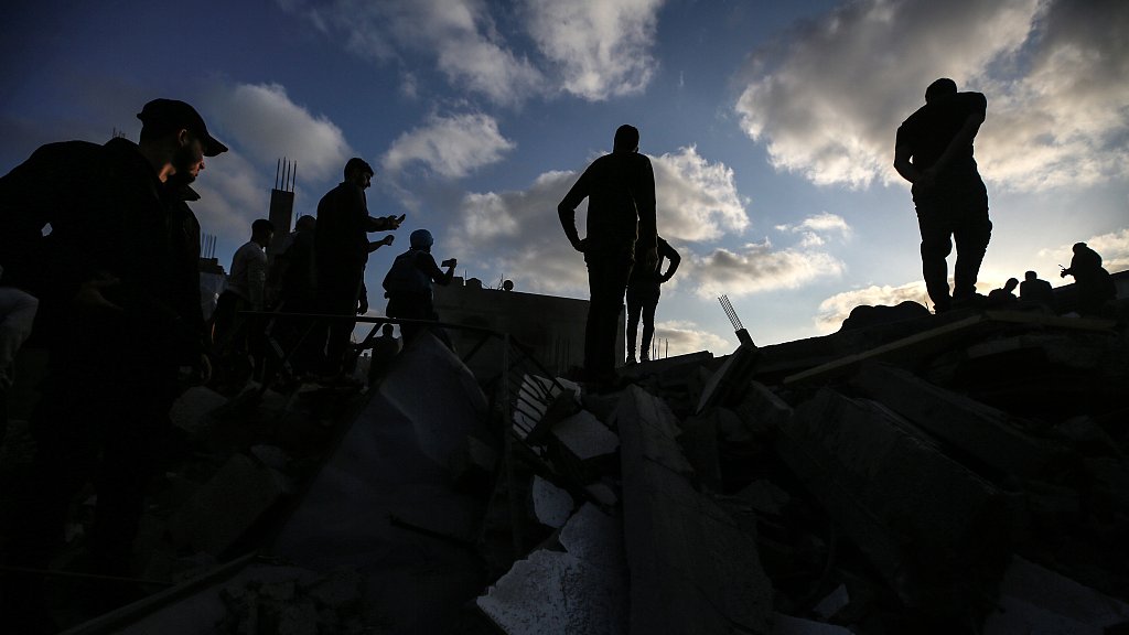 Palestinians inspect the rubble of a house after it was hit by an Israeli air strike in Gaza city on May 13, 2023. /CFP