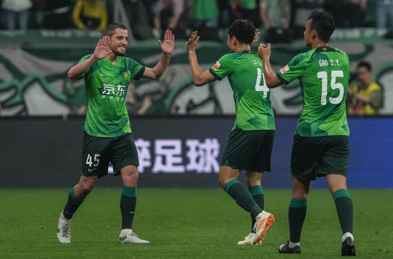 Beijing Guoan's Arijan Ademi (L) celebrate with Li Lei (C) and Gao Tianyi during their Chinese Super League clash with Nantong Zhiyun at the new Workers' Stadium in Beijing, China, May 15, 2023. /Beijing Guoan