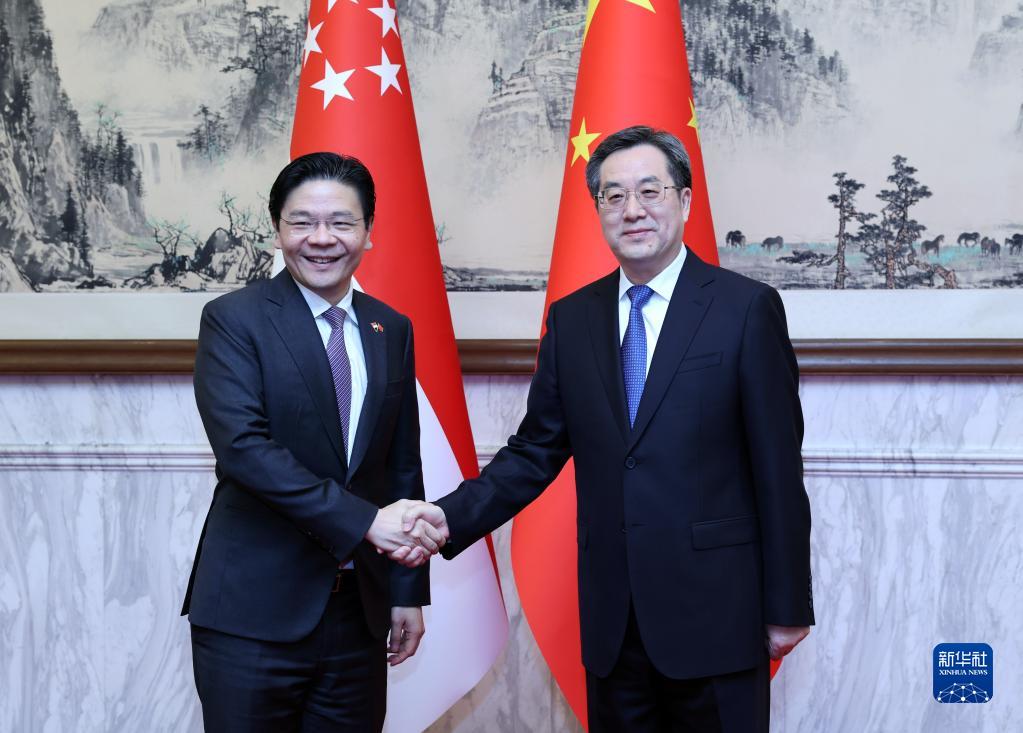Chinese Vice Premier Ding Xuexiang (R) holds talks with Deputy Prime Minister and Minister for Finance of Singapore Lawrence Wong in Beijing, China, May 16, 2023. /Xinhua