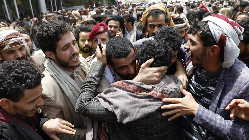A Yemeni conflict detainee is hugged by his relatives after he was freed in a prisoner exchange between warring sides at Sanaa International Airport in Sanaa, Yemen, April 16, 2023. /CFP