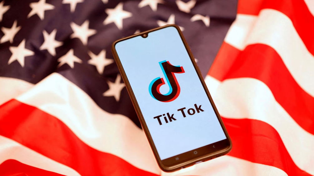 TikTok logo is displayed on the smartphone while standing on the U.S. flag in this illustration, November 8, 2019. /Reuters