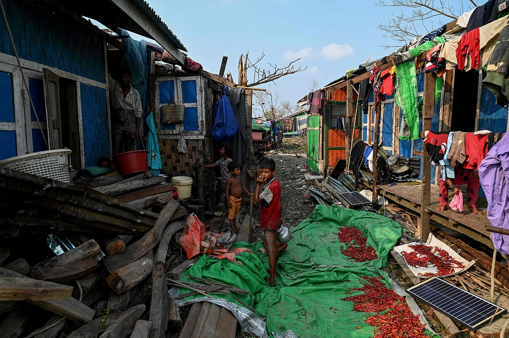 Children stand by destroyed houses at Ohn Taw Chay refugee camp in Sittwe in the aftermath of Cyclone Mocha's landfall, May 16, 2023. /CFP