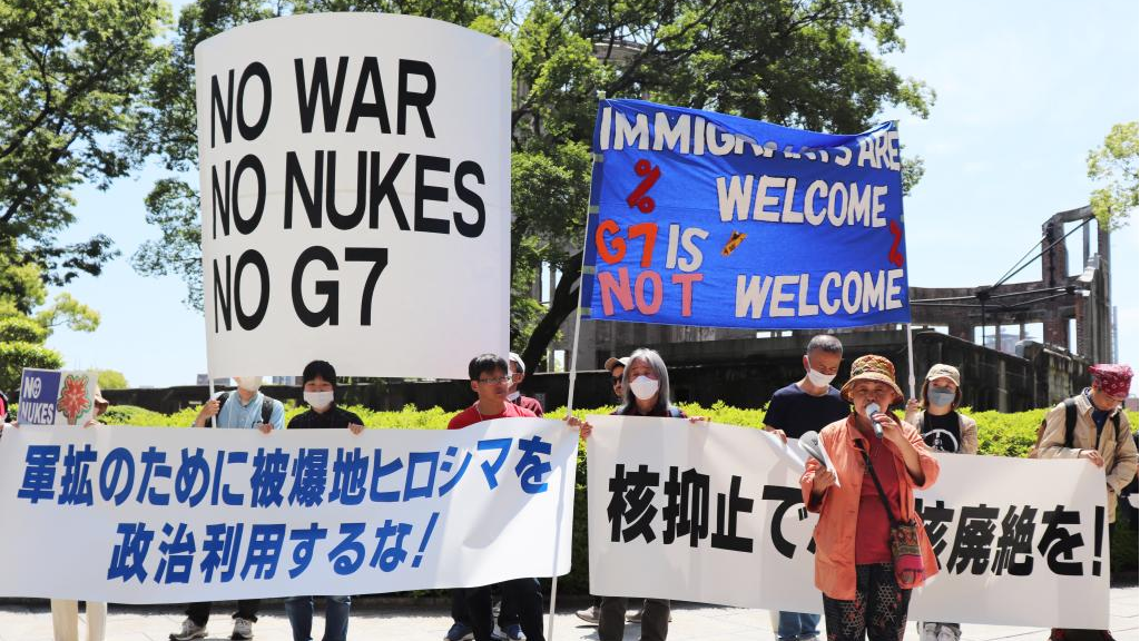 People holding banners protest against the Group of Seven (G7) summit at the site of the atomic bombing near the Peace Memorial Park in Hiroshima, Japan, May 14, 2023. /Xinhua