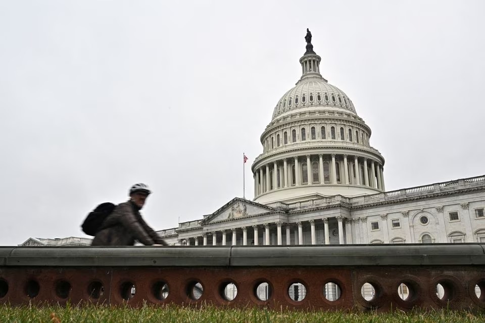 A cyclist passes by the U.S. Capitol building on the morning of the first day of the 118th Congress in Washington, D.C., U.S., January 3, 2023. Reuters/Jon Cherry/File Photo