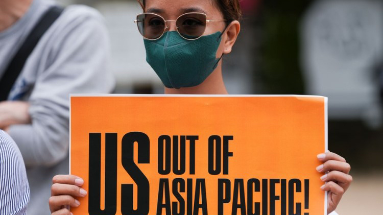 A demonstrator holds a placard at Hiroshima's Funairi Daiichi Park in a protest against the Group of Seven (G7) summit in Hiroshima, Japan, May 19, 2023. /Xinhua