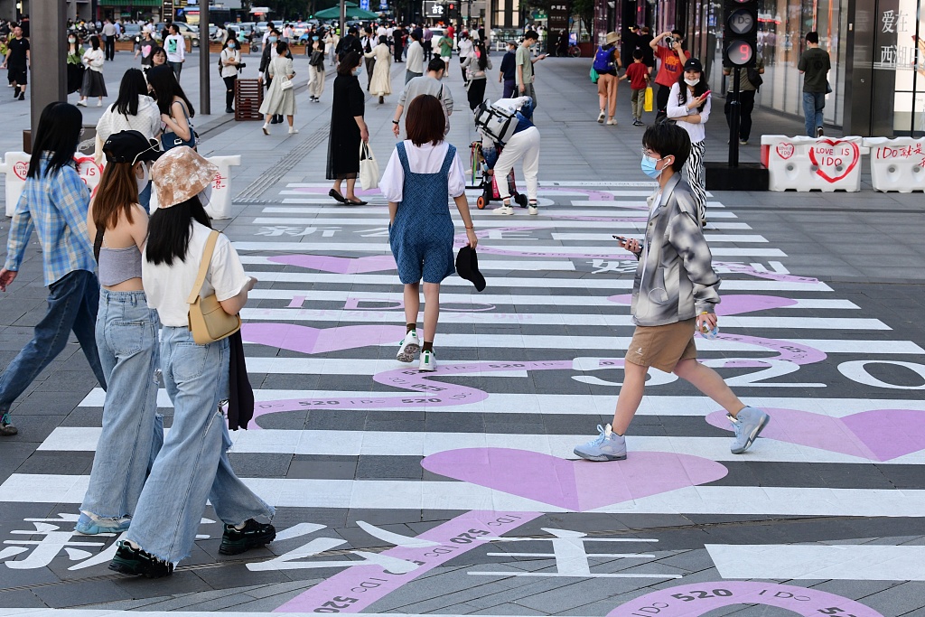 Pedestrians walk along a love and romance-themed zebra crossing on a street in Hangzhou, Zhejiang, May 17, 2022. /CFP