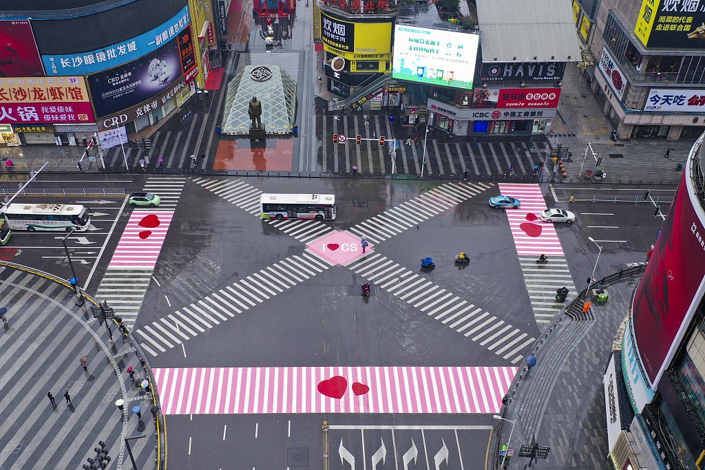 A crosswalk in Changsha, Hunan is painted pink embellished with red heart-shaped patterns, March 8, 2021. /CFP