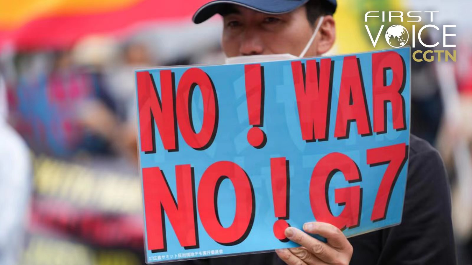 A man holds a placard at Hiroshima's Funairi Daiichi Park in a protest against the Group of Seven (G7) summit in Hiroshima, Japan, May 19, 2023. /Xinhua