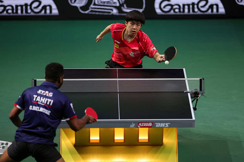 China's Wang Chuqin (top) competes against Ocean Belrose of Tahiti in the men's singles at the World Table Tennis Championships Finals in Durban, South Africa, May 21, 2023. /CFP