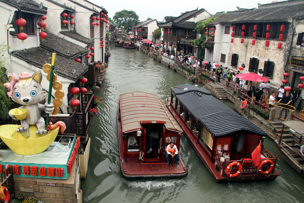 The photo, taken on May 21, shows tourist boats travel through the river that is situated in the ancient Shantang Street in the eastern Chinese city of Suzhou, Jiangsu Province. /CFP