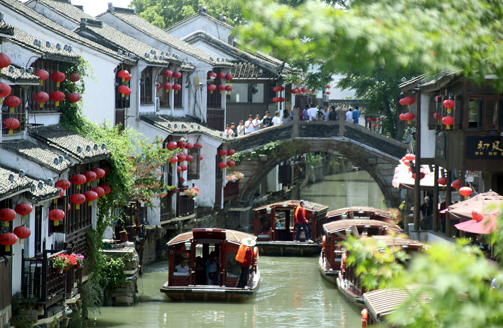 Tourists take a boat tour of Shantang Street in the ancient city of Suzhou, east China's Jiangsu Province, May 23, 2023. /CFP