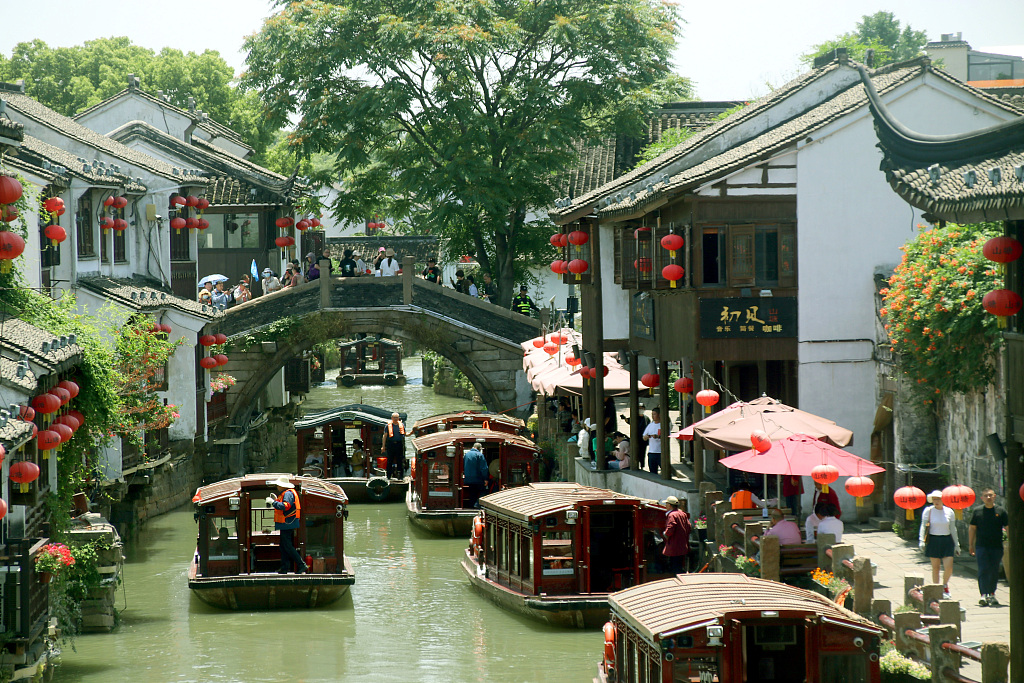 Tourists take a boat tour of Shantang Street in the ancient city of Suzhou, east China's Jiangsu Province, May 23, 2023. /CFP
