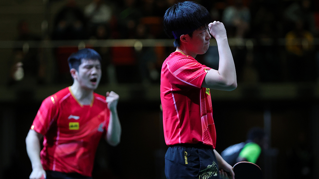Fan Zhendong (L) and Wang Chuqin celebrate during the men's doubles round of 32 at ITTF World Table Tennis Championships Finals in Durban, South Africa, May 23, 2023. /CFP