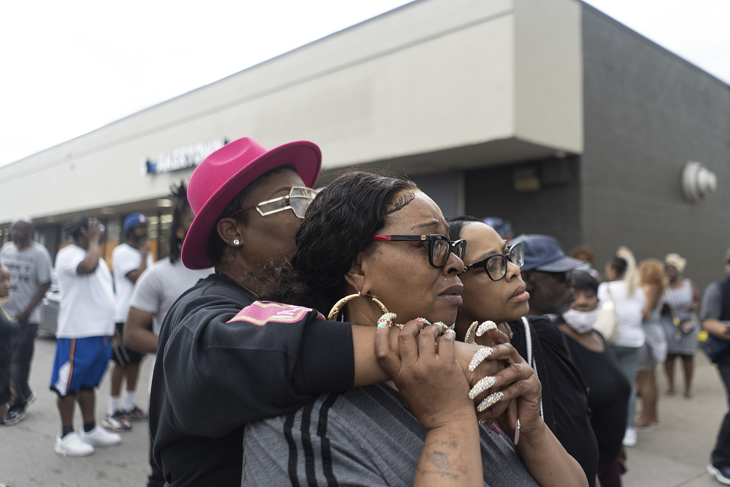 People watch the crime scene of an active shooter across the street from the Tops Friendly Market on Jefferson Avenue and Riley Street in Buffalo on May 14, 2022. /CFP