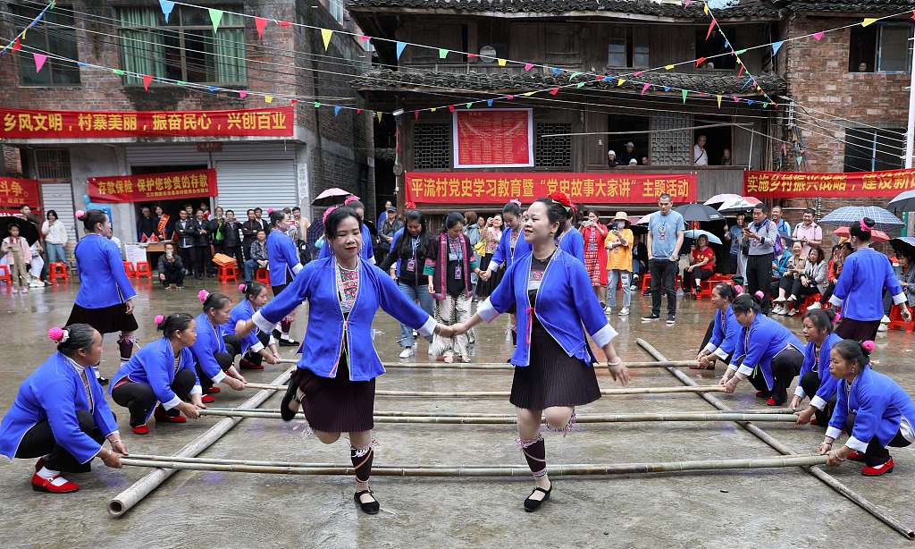 Dong people enjoy bamboo pole dance in Pingliu Village of Liuzhou, south China's Guangxi Zhuang Autonomous Region to celebrate Wufan Festival. /CFP