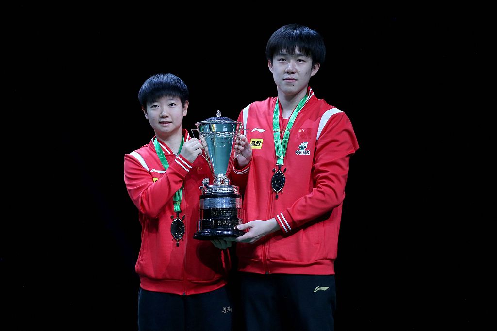 Sun Yingsha (L) and Wang Chuqin of China pose with the mixed doubles trophy after defeating Tomokazu Harimoto and Hina Hayata of Japan in the event's final at the International Table Tennis Federation World Table Tennis Championships Finals in Durban, South Africa, May 26, 2023. /CFP