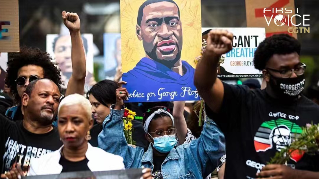 People raise their fists as they march during an event in remembrance of George Floyd in Minneapolis, Minnesota on May 23, 2021. /CFP