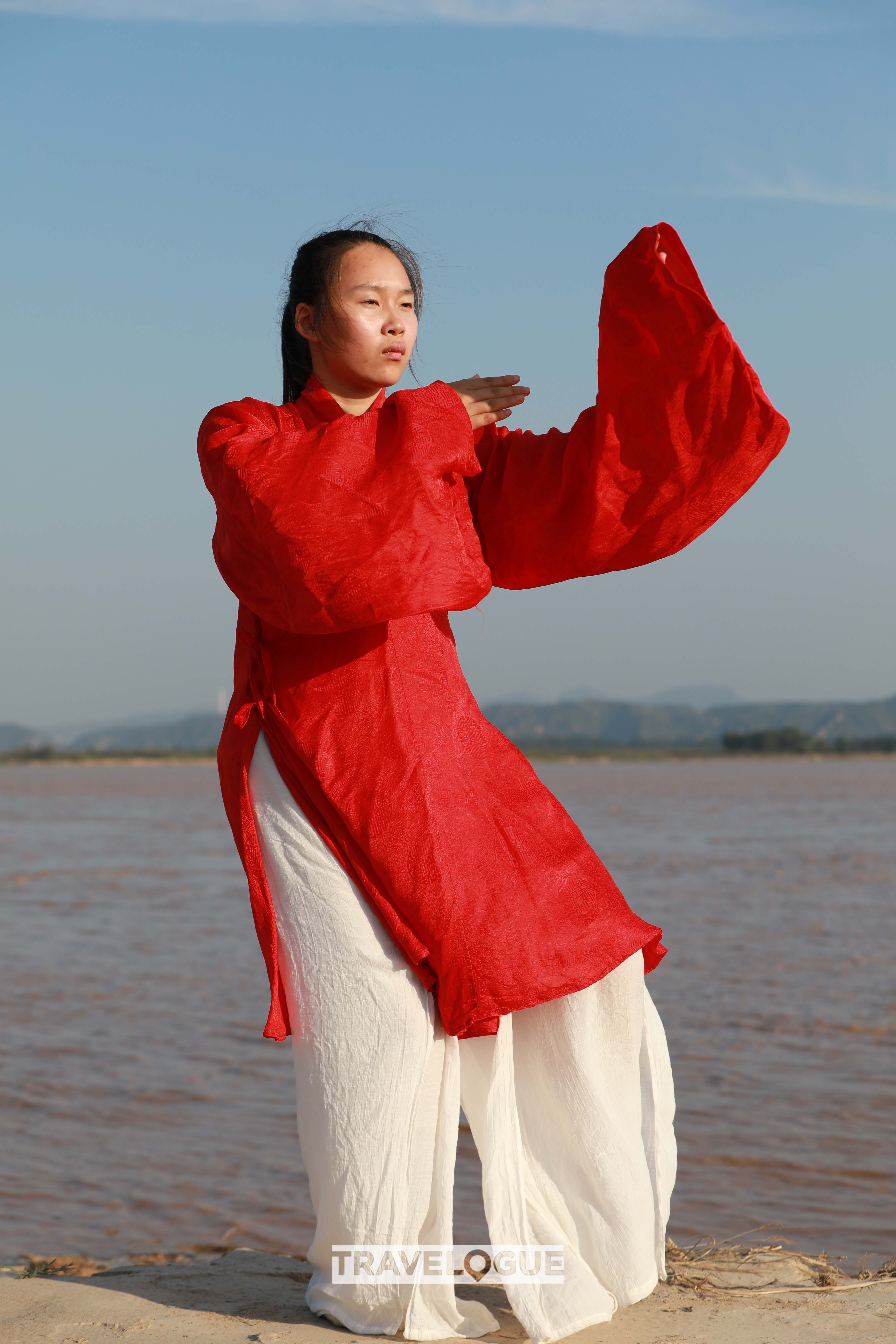 A woman practices Tai Chi in Chenjiagou, central China's Henan Province. /CGTN 