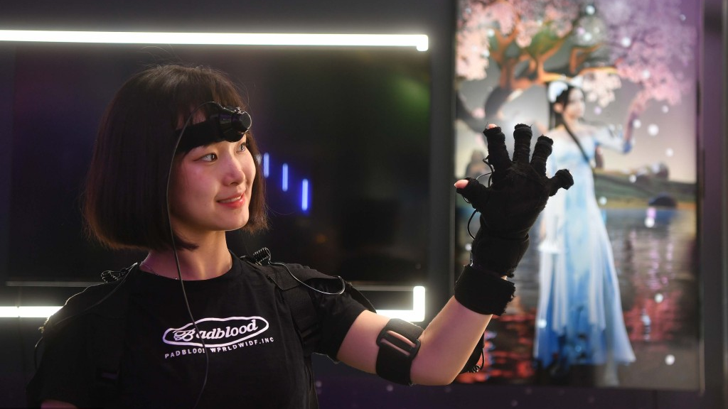 A woman demonstrates a motion capture device in the exhibition area at the Zhongguancun Forum in Beijing, capital of China, May 24, 2023. /VCG