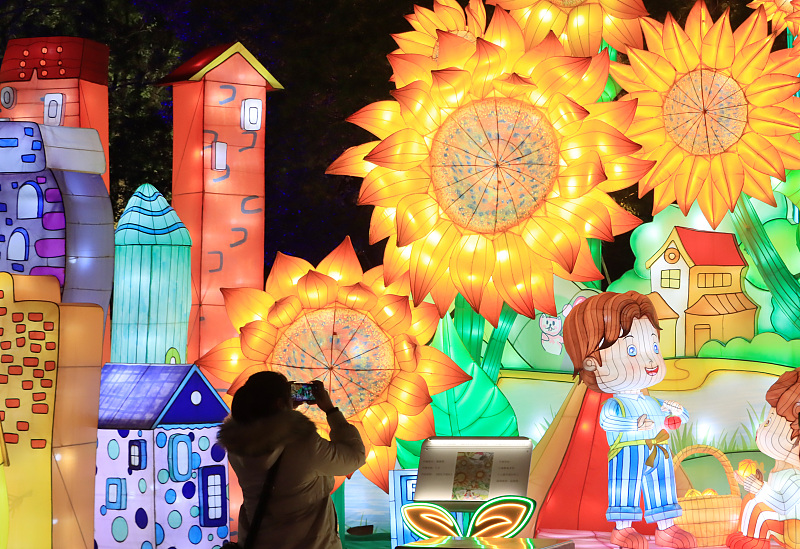 A visitor takes photos of lanterns at the China Dinosaurs Park in Changzhou City, Jiangsu Province. /CFP