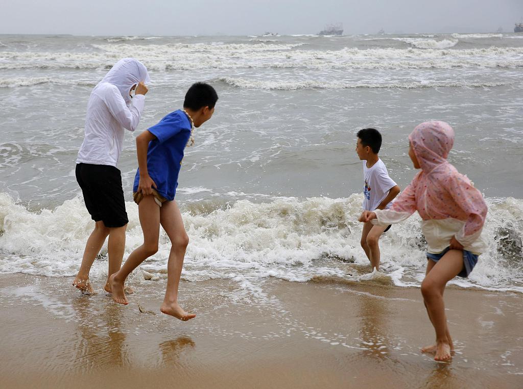 Children play at a beach in Sanya, south China's Hainan. /CFP