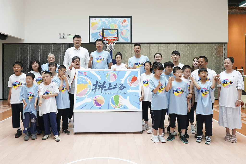 Members of the Chinese Basketball Association pose for a photo with Special Olympics athletes in the 