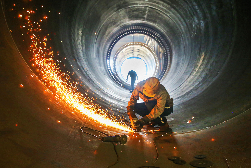 A worker works in the production shop of a wind power equipment manufacturing enterprise in Lianyungang, Jiangsu Province, China, May 31, 2023. /CFP
