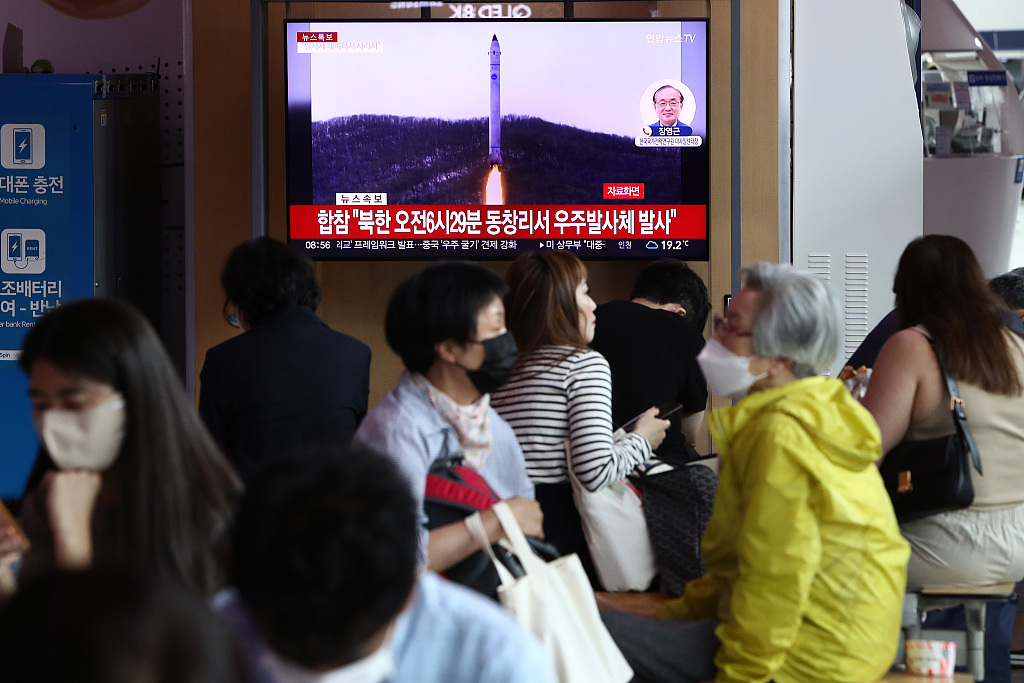 People watch a television broadcast showing a file image of a DPRK rocket launch at Seoul Railway Station, Seoul, ROK, May 31, 2023. /CFP