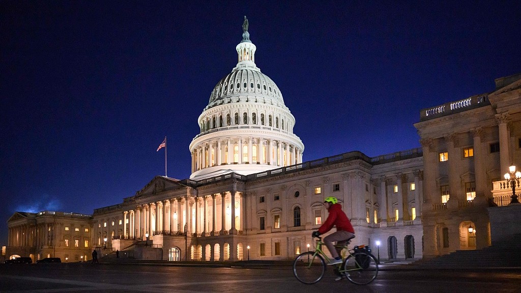 A bicyclist rides past the U.S. Capitol at dusk, Washington, DC, U.S. /CFP