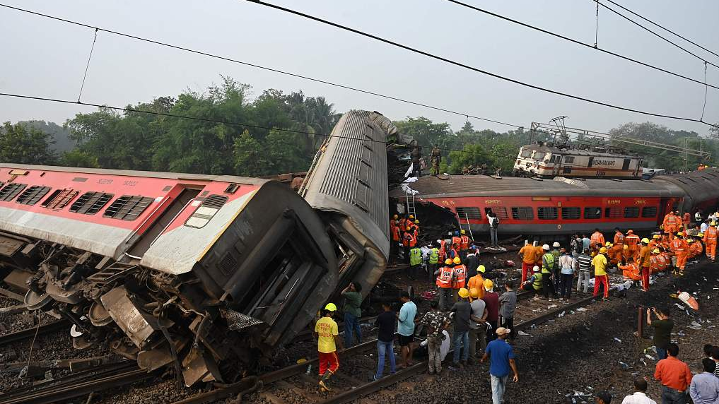 Rescue workers gather around damaged carriages during a search for survivors at the accident site of the three-train collision in the eastern state of Odisha, India, June 3, 2023. /CFP