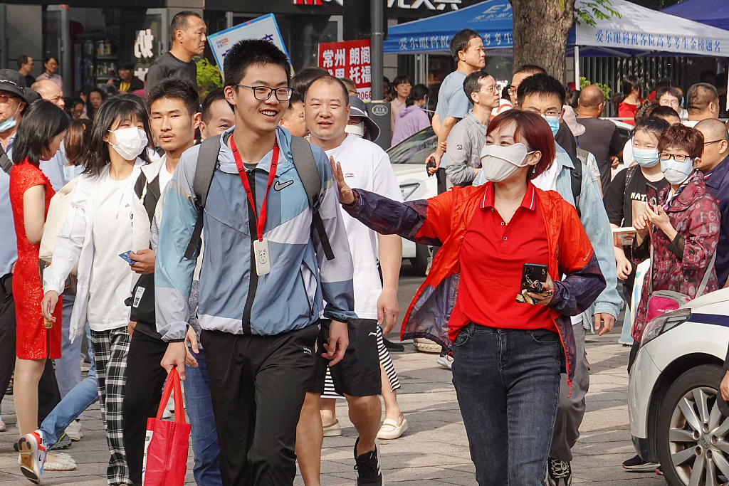 A parent pats her son to encourage him before he enters an examination room in Changzhou, Jiangsu Province on June 7, 2023. /CFP