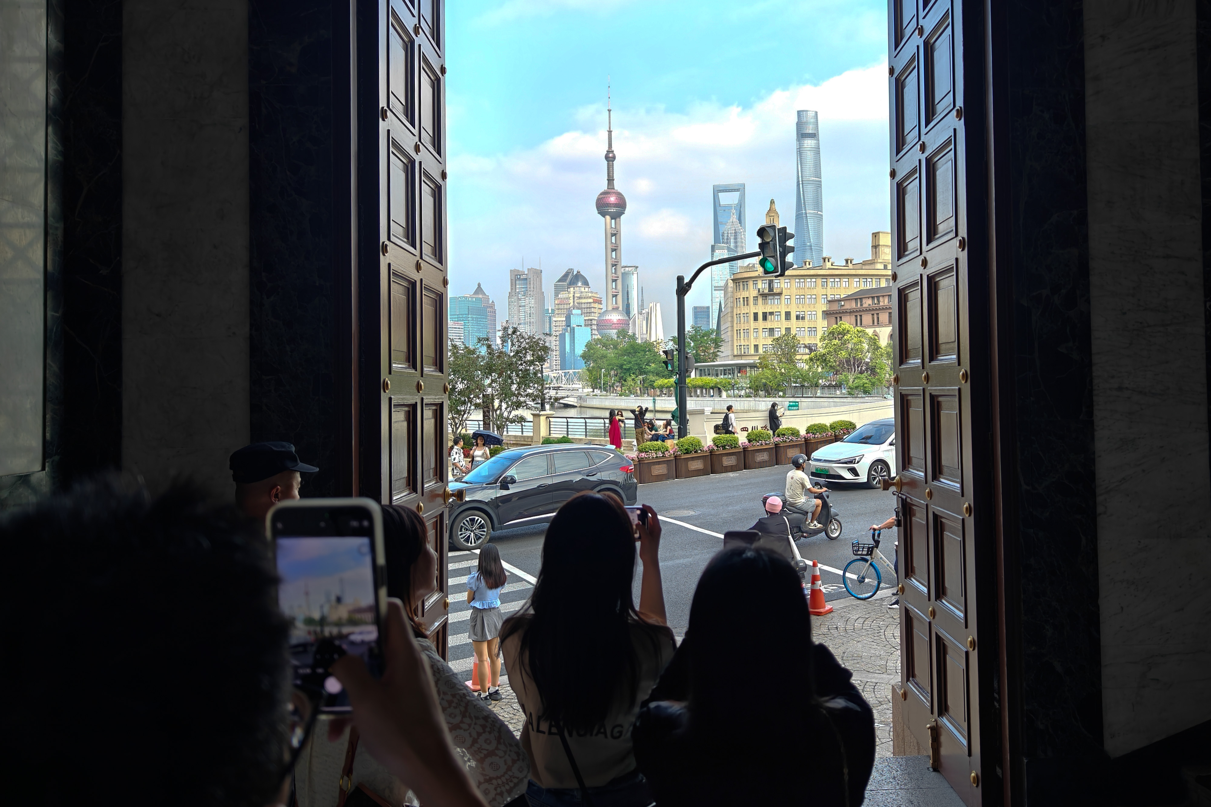 Tourists take cityscape photos in the lobby of the General Post Office Building in Shanghai on June 6, 2023. /CNSPHOTO