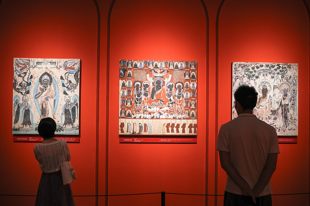 Visitors stand in a hall of the Jiangxi Museum in Nanchang, Jiangxi as they take in 60 porcelain works painted with Dunhuang mural patterns on June 9, 2023. /CFP