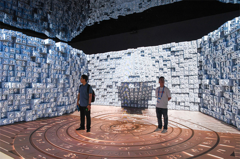 People watch the 3D display of movable-type printing at the 19th China (Shenzhen) International Cultural Industries Fair in Shenzhen, Guangdong Province, June 8, 2023. /Xinhua
