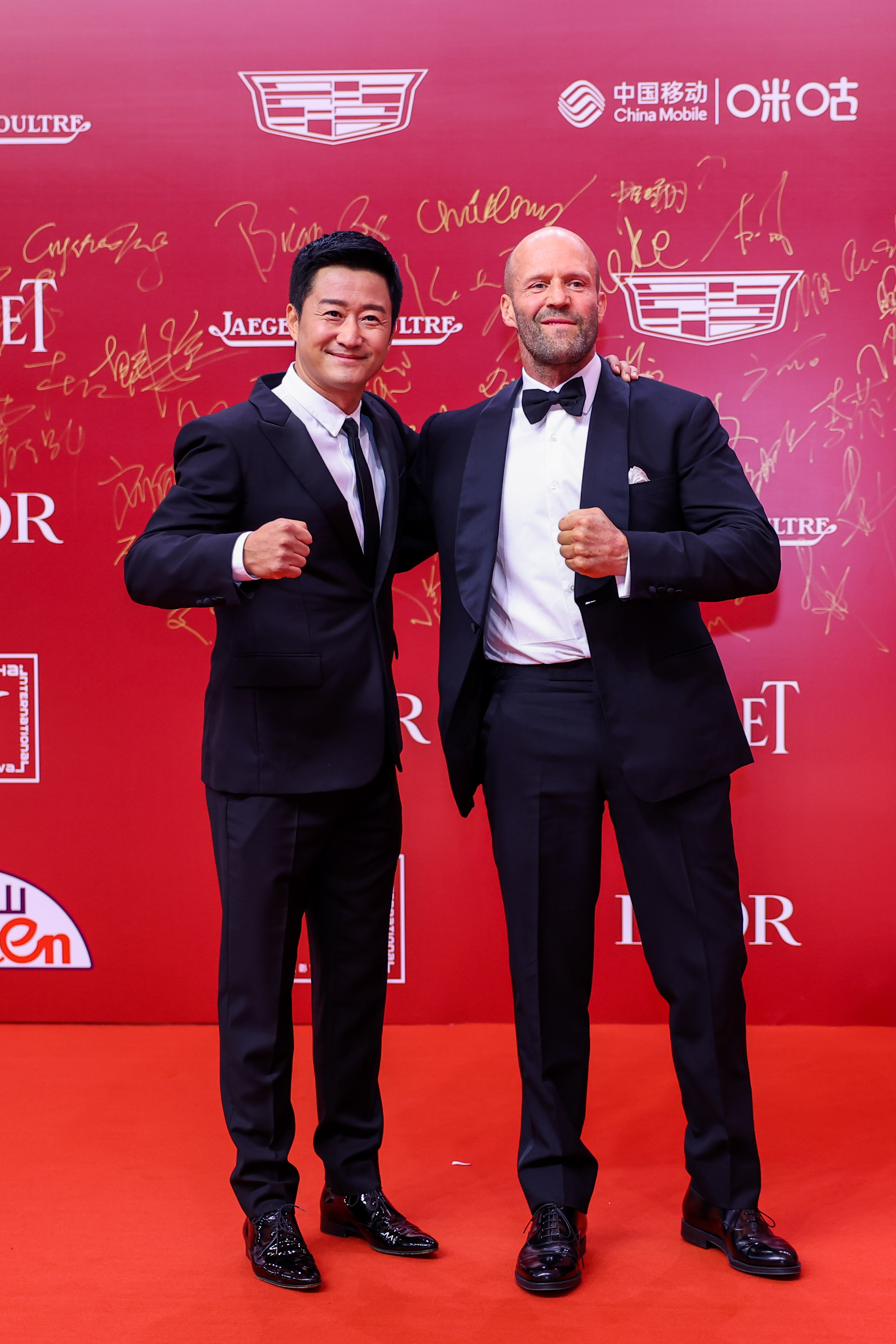 Chinese actor Wu Jing and British action star Jason Statham appear on the red carpet at the opening of the 25th Shanghai International Film Festival at the Shanghai Grand Theater on Friday, June 9, 2023. /SIFF
