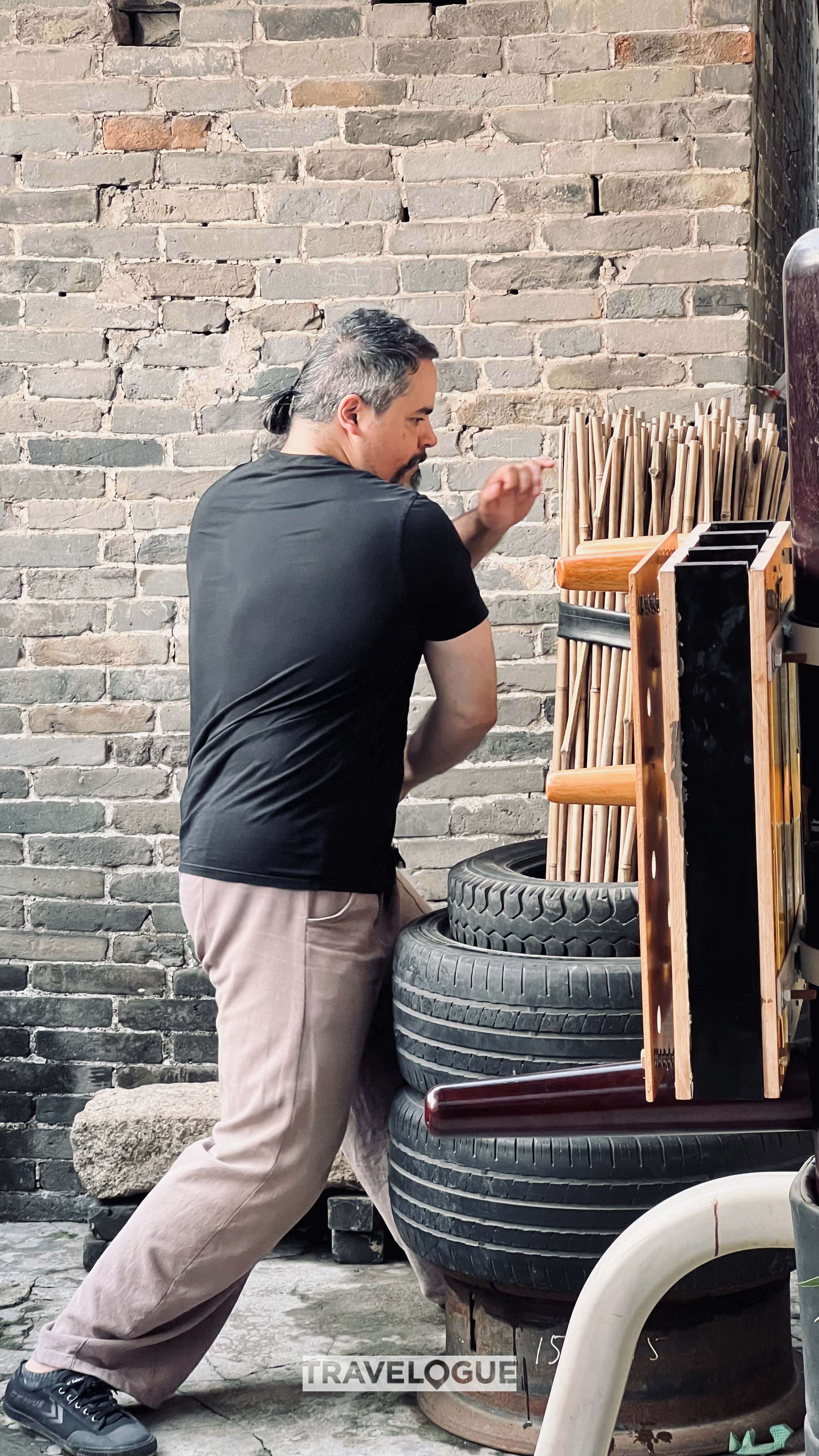 A man uses a wooden dummy to practice snake-style Wing Chun in Foshan, south China's Guandong, in this undated photo. /CGTN