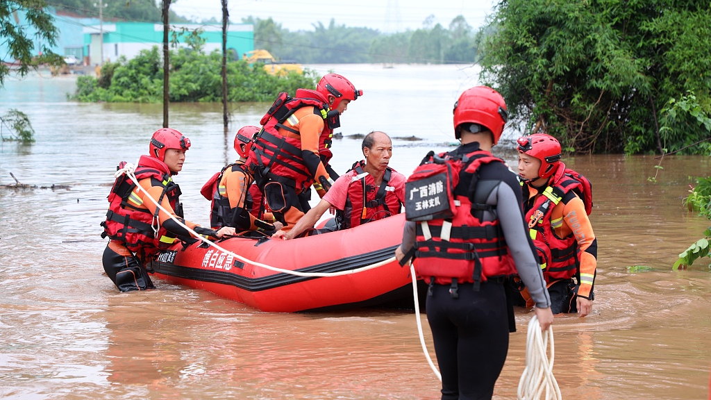 Firefighters help evacuate people trapped by floods in Beihai City of south China's Guangxi Zhuang Autonomous Region on June 9, 2023. /CFP
