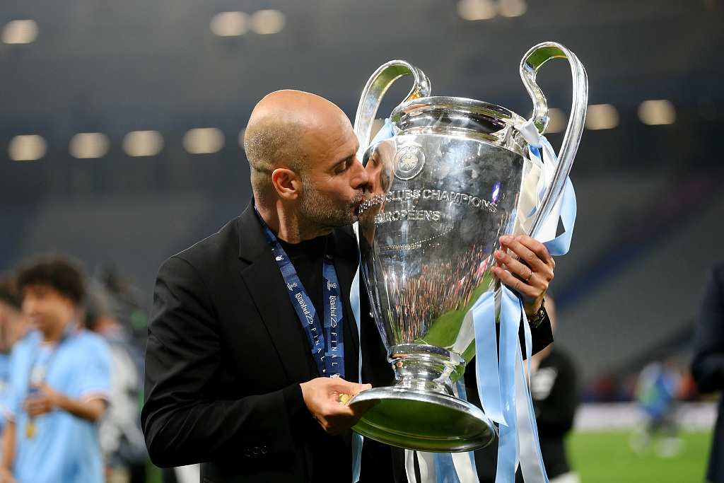 Manchester City manager Pep Guardiola kisses the Champions League trophy at Ataturk Olympic Stadium in Istanbul, Türkiye, June 10, 2023. /CFP