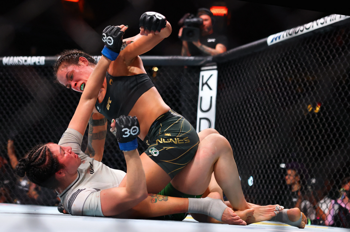 Amanda Nunes unleashes punches from the top position on Irene Aldana. /Zuffa