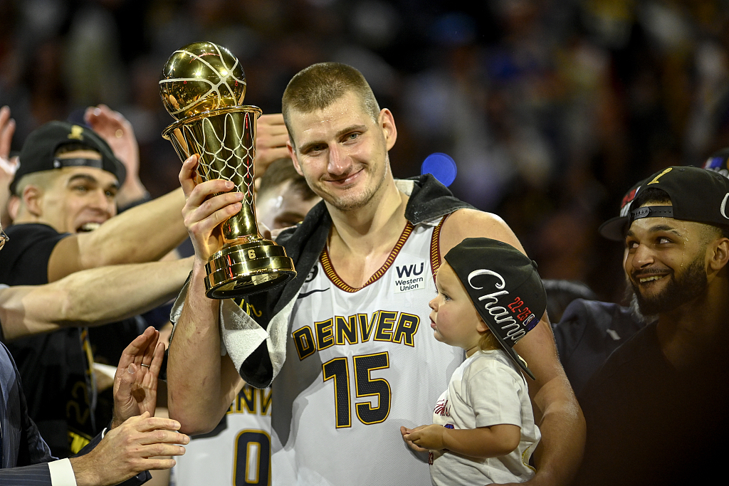 Nikola Jokic (#15) of the Denver Nuggets holds the Bill Russell NBA Finals Most Valuable Player trophy after beating the Miami Heat 4-1 in the series to win the NBA championship at Ball Arena in Denver, Colorado, June 12, 2023. /CFP