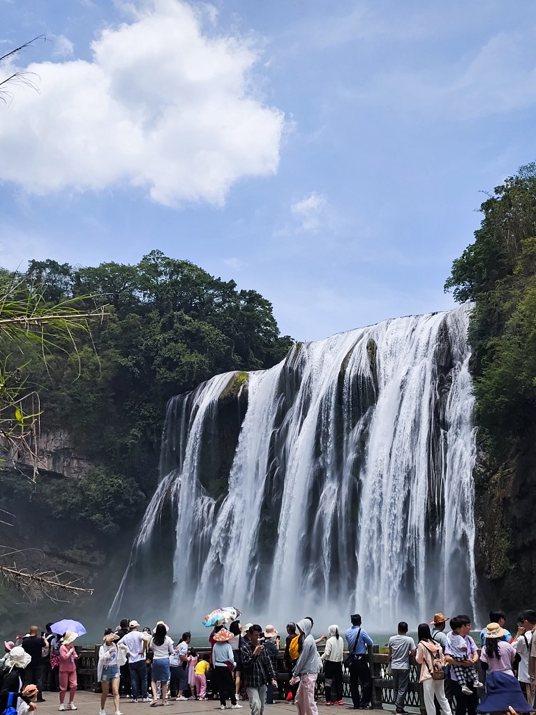 The Huangguoshu Waterfall in Anshun, Guizhou attracts numerous visitors to appreciate its spectacular appearance and seek respite from the summer heat, June 13, 2023. /CFP
