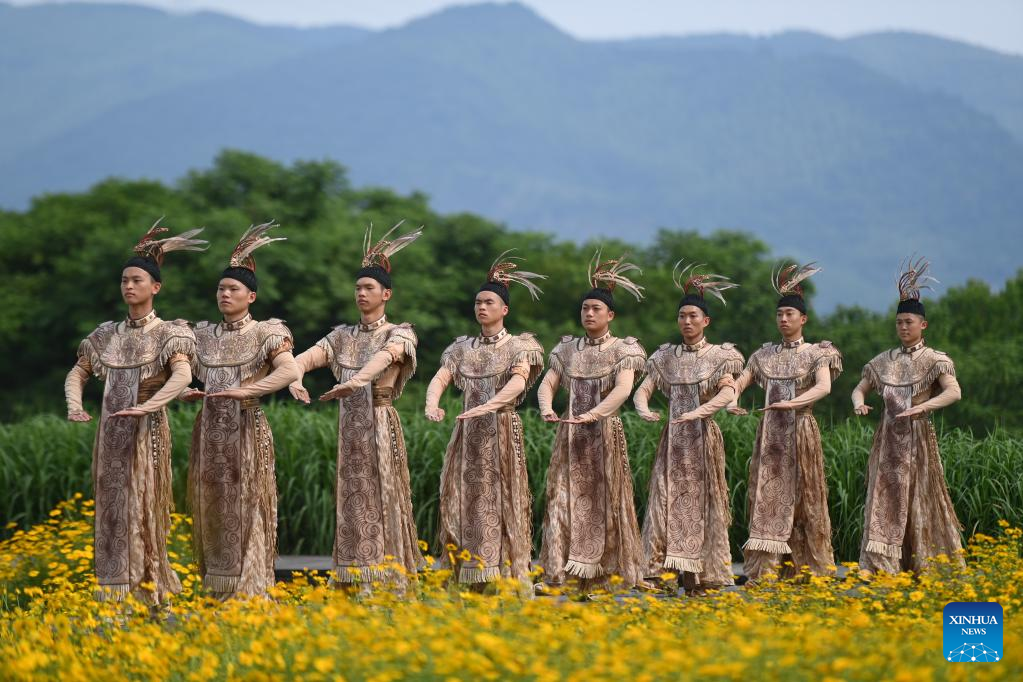 Dancers, playing roles of ancient Liangzhu villagers, perform during the Hangzhou 2022 Asian Games Flame Lighting Ceremony at the Archaeological Ruins of Liangzhu City park in Hangzhou, east China's Zhejiang Province, June 15, 2023. /Xinhua