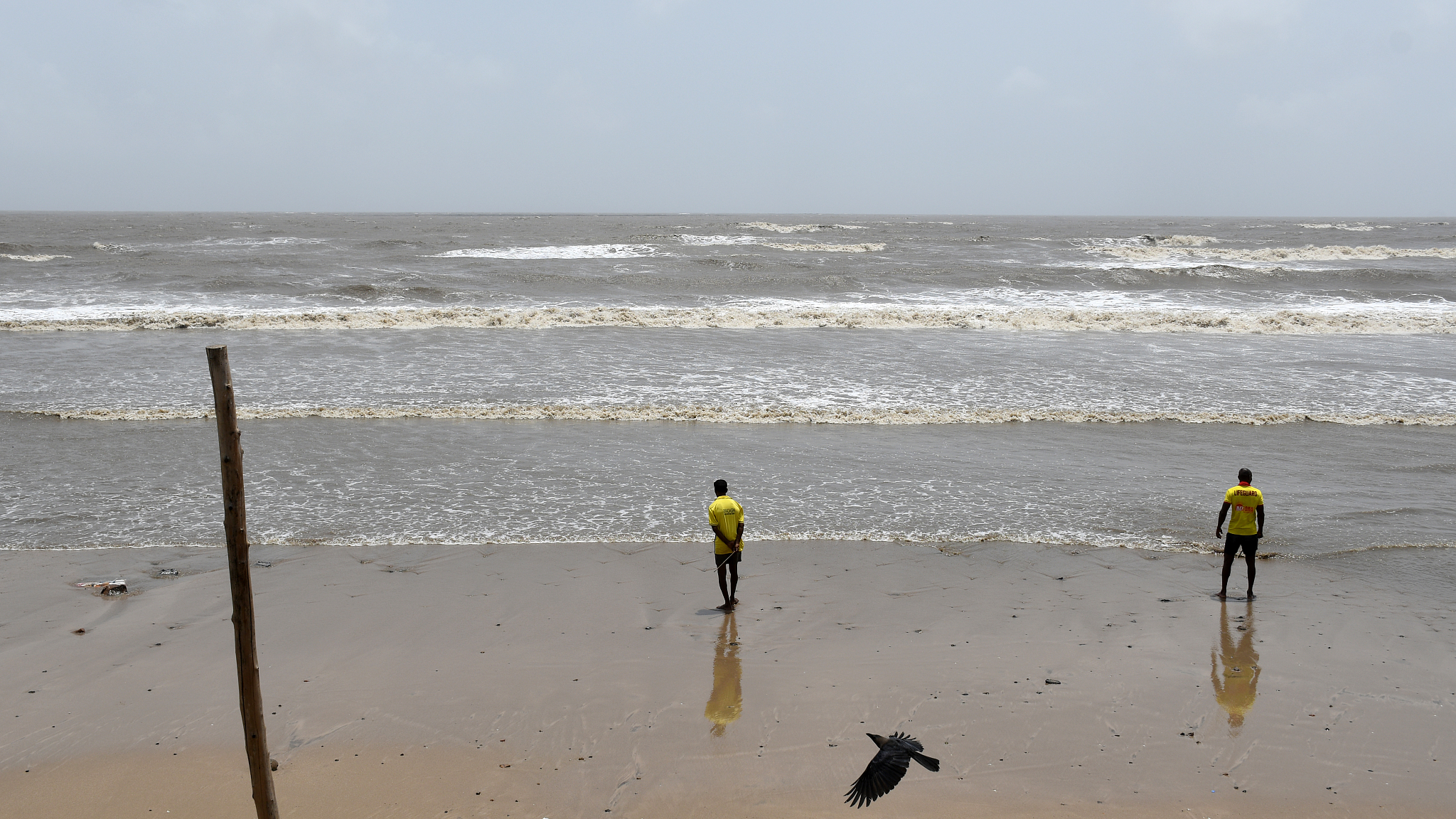 Lifeguards are seen standing on the beach as a precautionary measure ahead of cyclone Biparjoy in Mumbai, India, June 14, 2023. /CFP