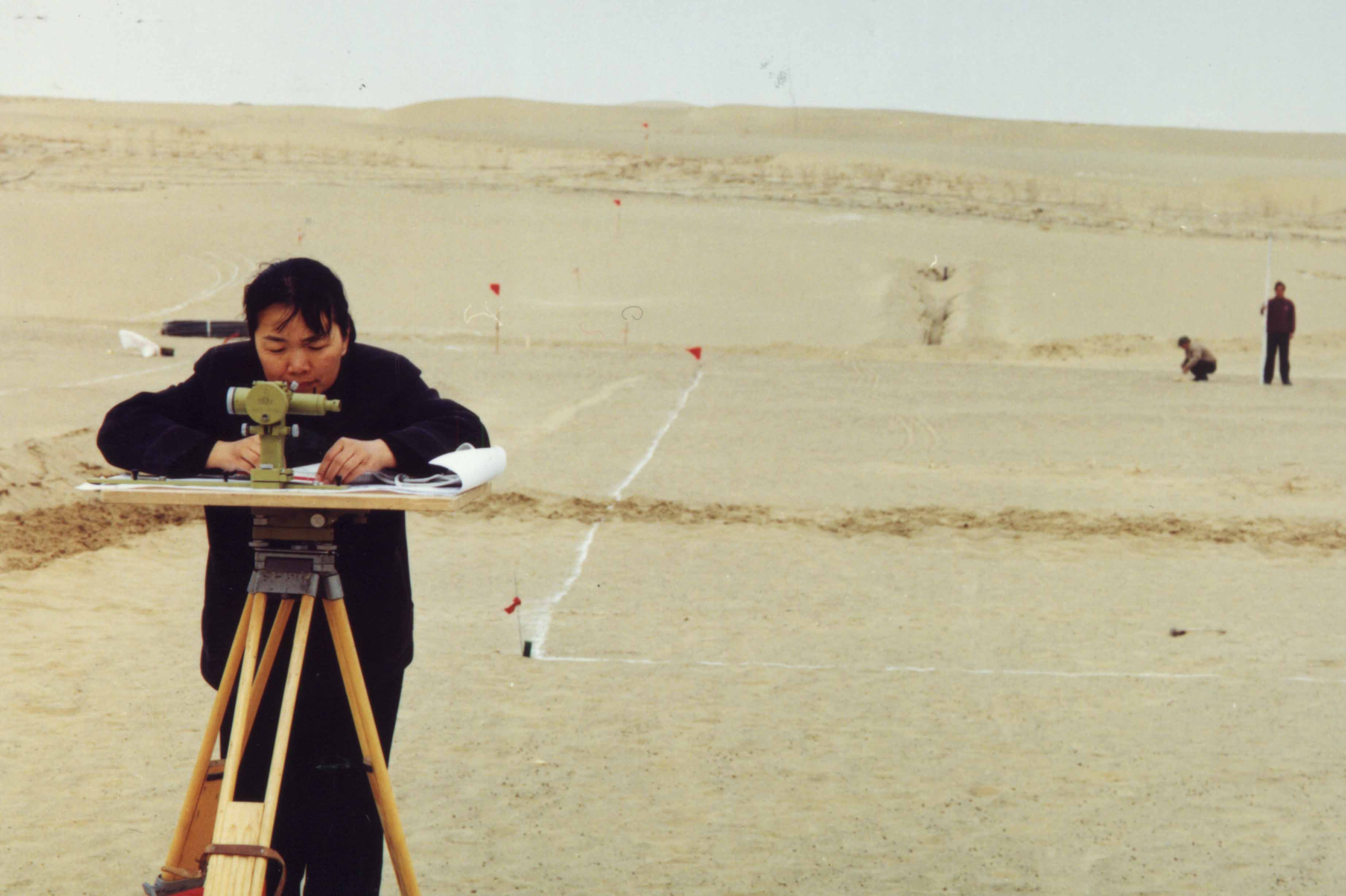 Surveying the site according to the drawings before construction of Tazhong botanical garden, 2002. 
