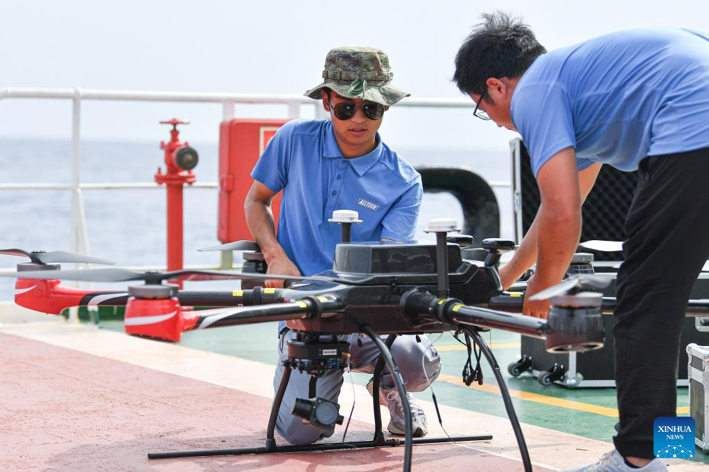 Employees test an unmanned aerial vehicle for conducting open-sea testing of the low-Earth orbit broadband communication test constellation at the 