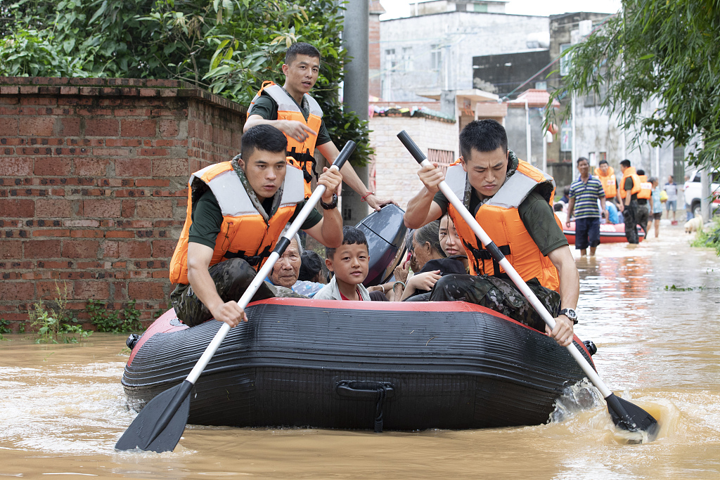 Chinese soldiers transport residents who were affected by floods with an inflatable canoe, Beihai City, south China's Guangxi Zhuang Autonomous Region, June 9, 2023. /CFP