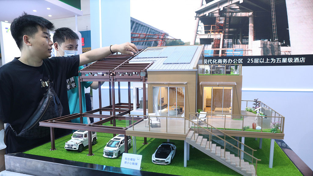 Visitors check out a model of a low-carbon house at the China International Housing Industry Expo, Beijing, China, June 19, 2023. /CFP