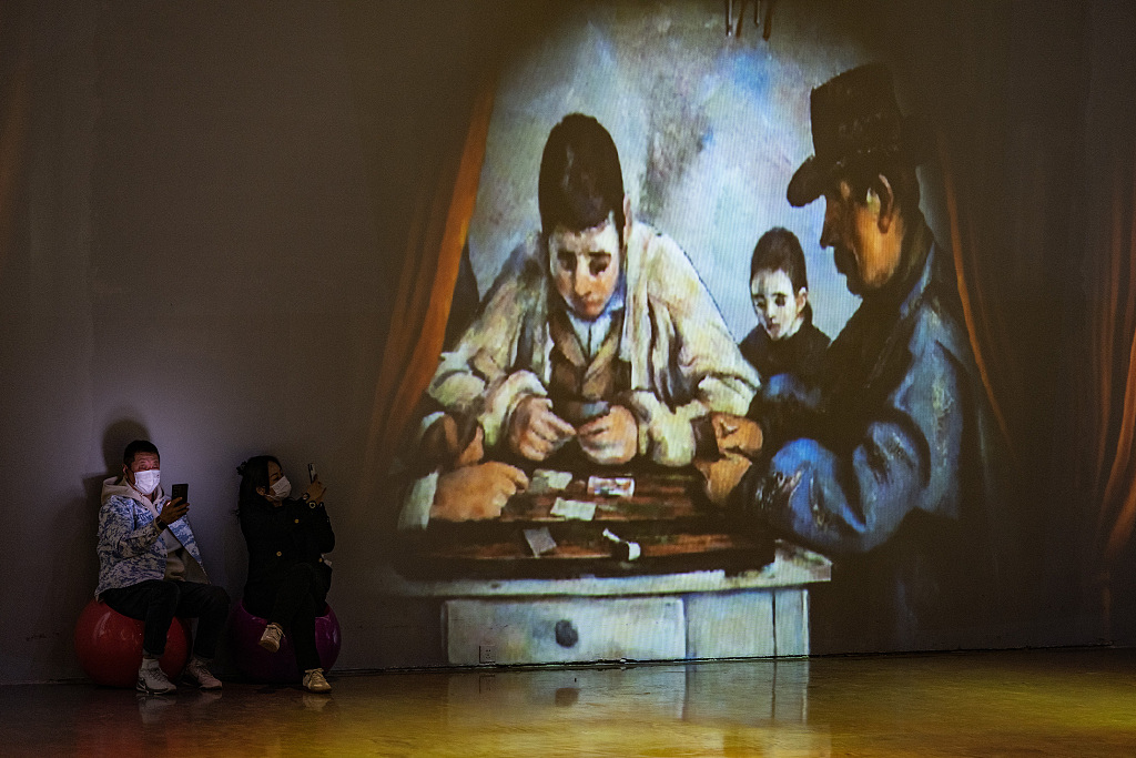 An oil painting by Paul Cezanne is projected onto a wall at an exhibition in Beijing, March 24, 2023. /CFP