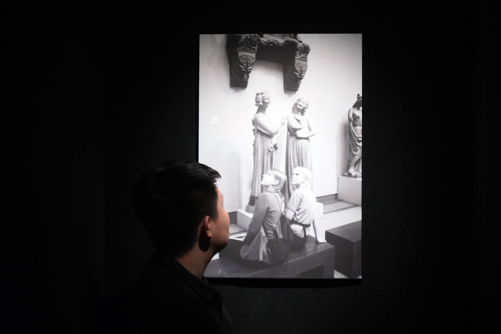A visitor admires a photo by French photographer Gerard Uferas exhibited at the 1905 Cultural and Creative Park in Shenyang, Liaoning, April 30, 2023. /CFP