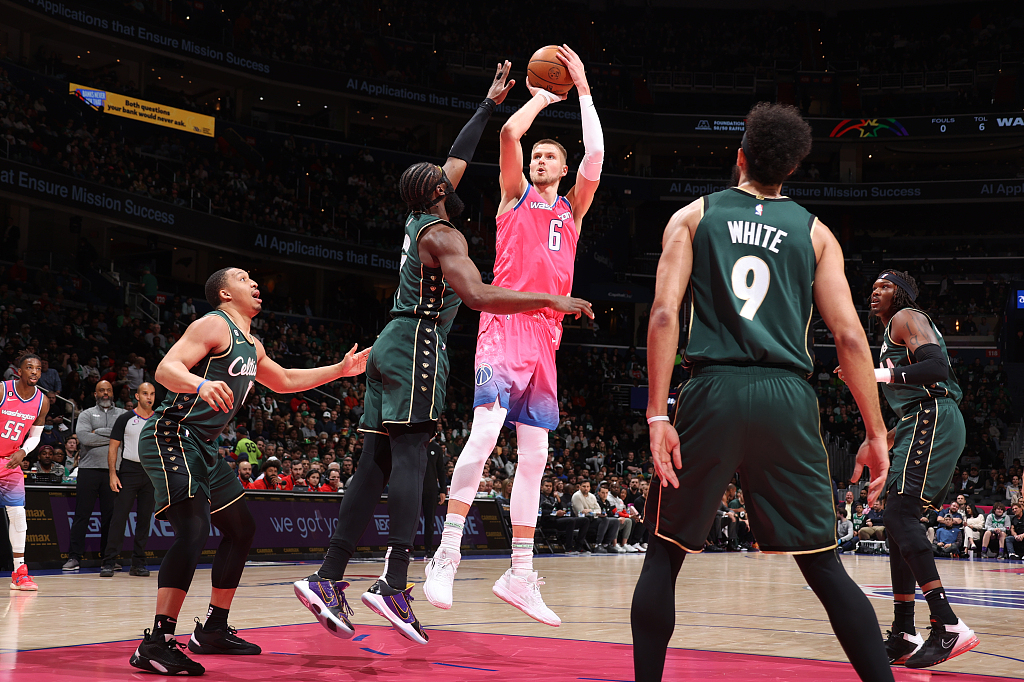 Kristaps Porzingis (#6) of the Washington Wizards shoots in the game against the Boston Celtics at Capital One Arena in Washington, D.C., March 28, 2023. /CFP